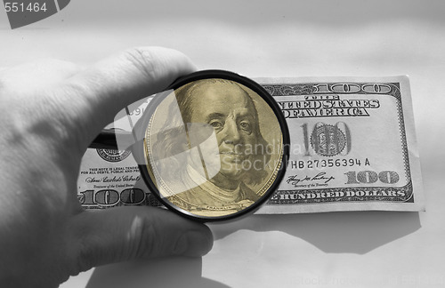 Image of dollars and magnifying glass