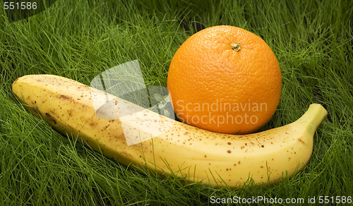 Image of orange and banana on grass