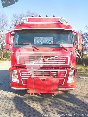 Image of Front view of a red truck in urban area