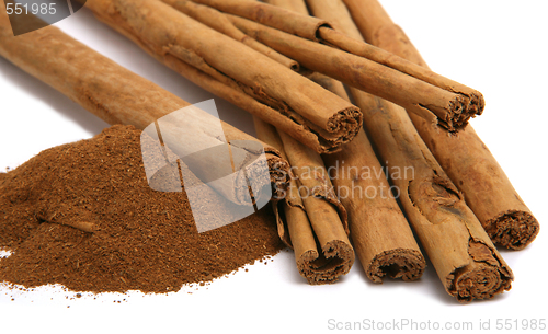 Image of cinnamon powder and bark isolated on white