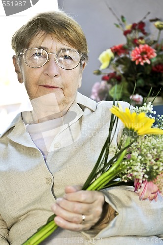 Image of Elderly woman with flowers