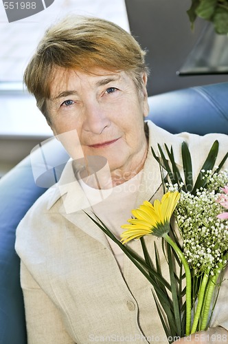 Image of Elderly woman with flowers