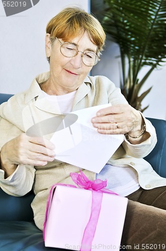 Image of Old woman opening present