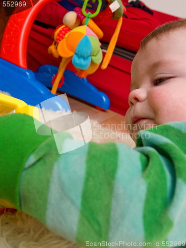 Image of Cute little baby boy playing with toys