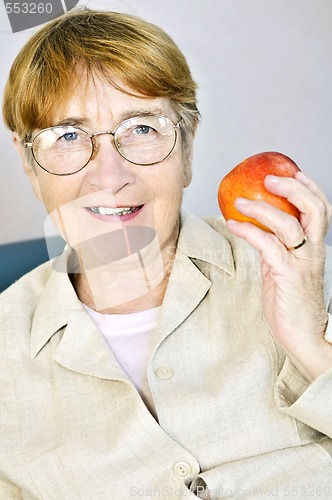 Image of Elderly woman with apple