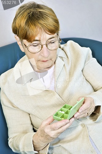 Image of Elderly woman with pill box