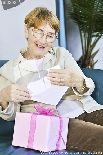 Image of Old woman opening present