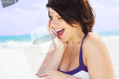 Image of woman with laptop computer on the beach