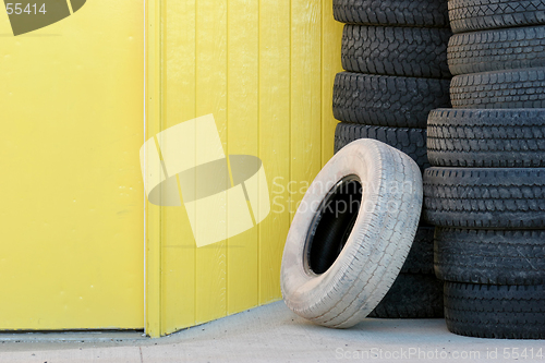 Image of stack of tires against yellow wall