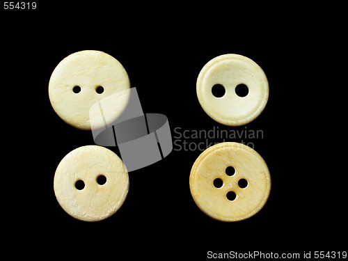 Image of four white buttons