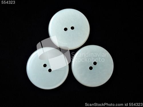 Image of three round white buttons