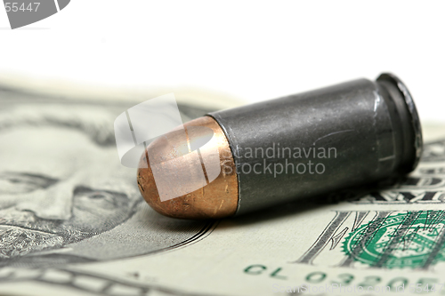 Image of bullet over dollars