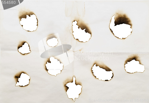 Image of burnt holes in a paper