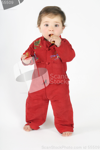 Image of Standing baby eating rusk