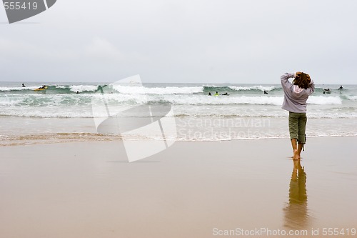 Image of girl looking at surfers