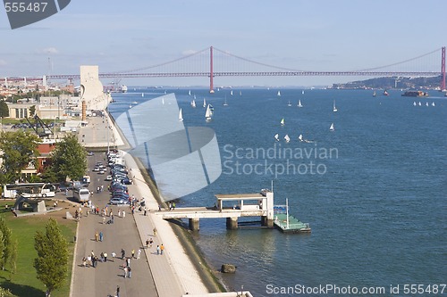 Image of wide river with yachts and modern bridge