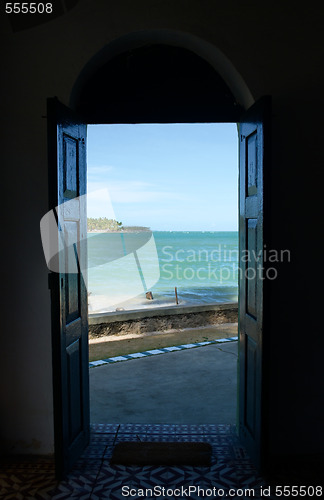 Image of Tropical beach in Brazil seen through a window door