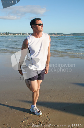 Image of Stretching Exercises On The Beach