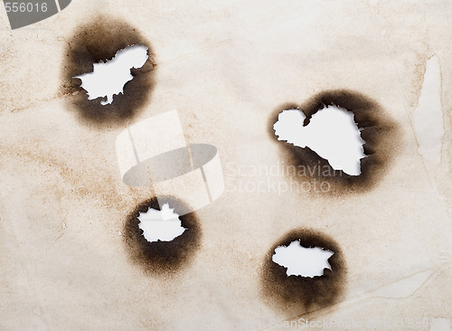 Image of burnt holes in a paper