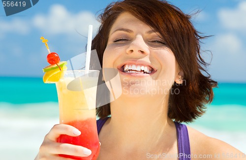 Image of happy woman with colorful cocktail