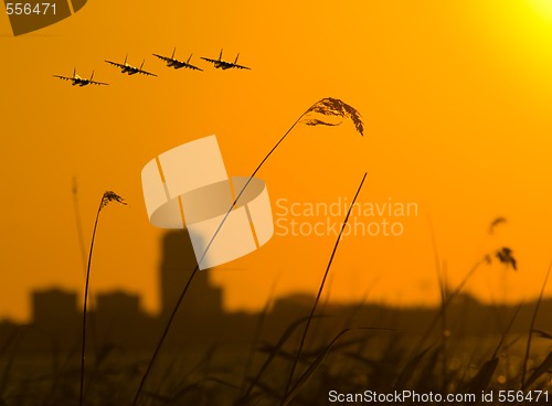 Image of four fighters over sunset