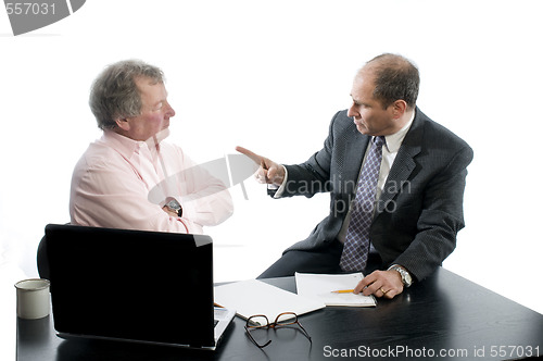 Image of two business partners at desk shaking hands