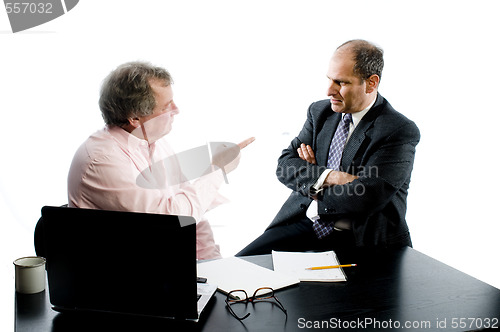 Image of two business partners at desk shaking hands