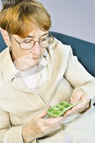 Image of Elderly woman with pill box