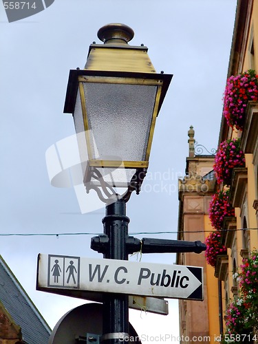 Image of Street lamp with a sign for public toilets in France
