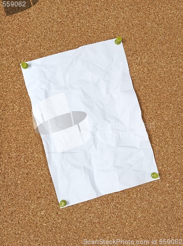 Image of Crumpled paper pinned to corkboard