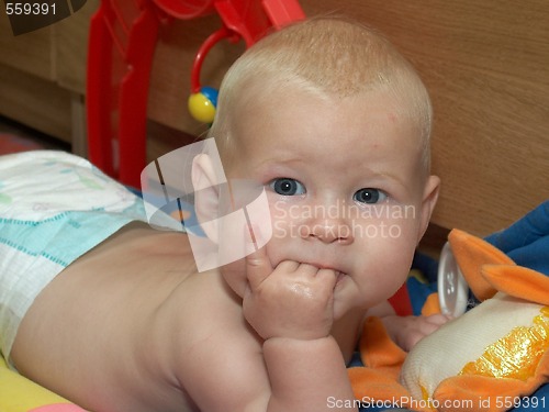 Image of baby with a hand in a mouth