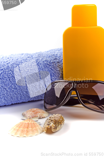 Image of towel, sunglasses and lotion