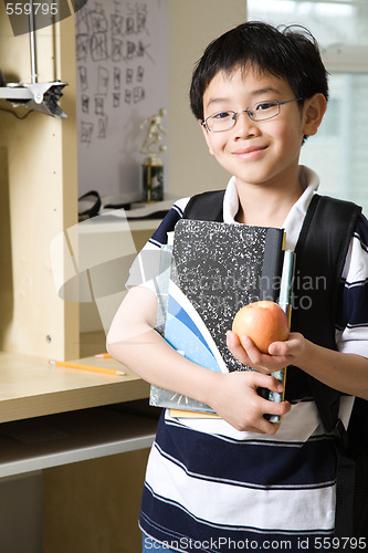 Image of Studying kid with an apple