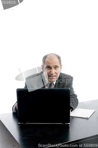 Image of senior executive at desk successful