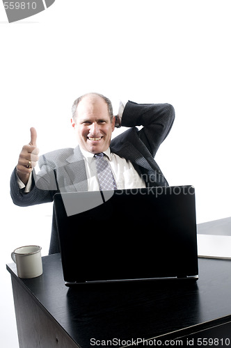 Image of senior executive at desk successful