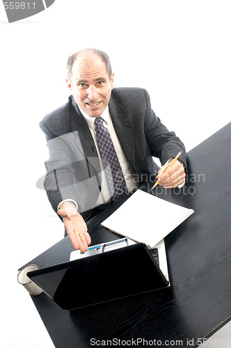 Image of senior executive at desk successful