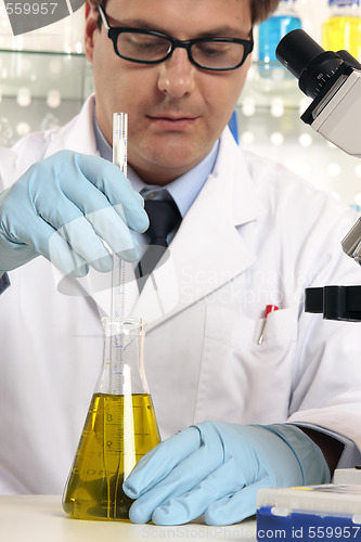 Image of Scientist mixing liquids chemicals