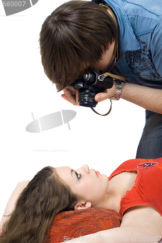 Image of Photographer taking pictures of the young woman