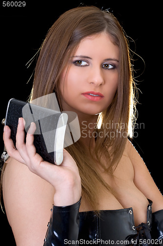Image of Beautiful young woman with a flask over black