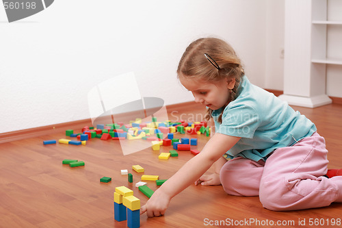Image of Adorable girl playing with blocks
