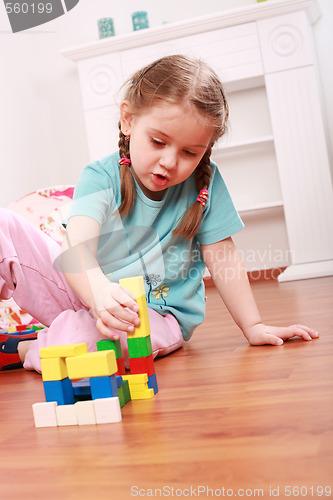 Image of Adorable girl playing with blocks