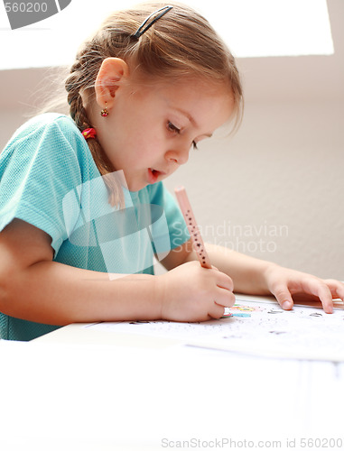 Image of Cute little girl painting at home