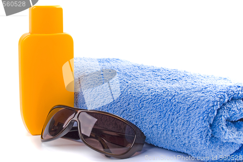 Image of towel, sunglasses and lotion