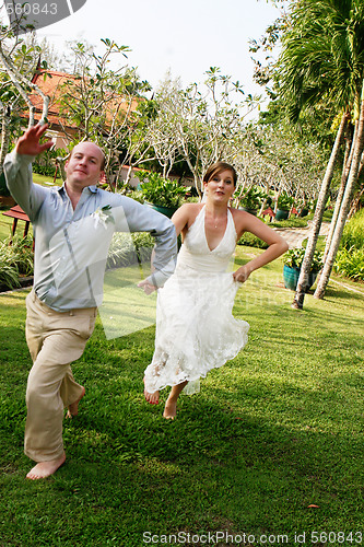 Image of Bride and groom jumping.