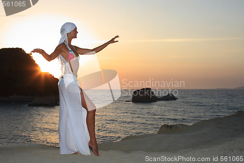 Image of Woman meditating at sunset