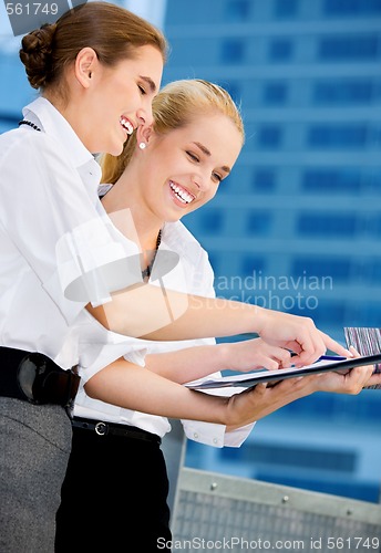 Image of two happy businesswomen with paper chart