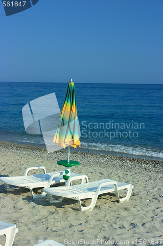 Image of Folded umbrella on a beach