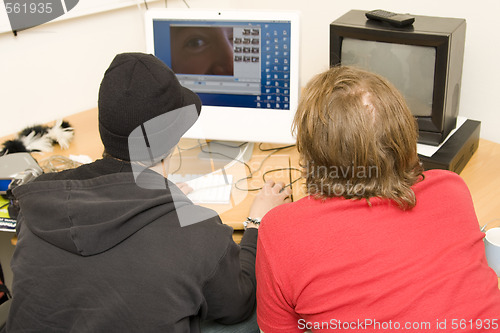 Image of students editing video on computer