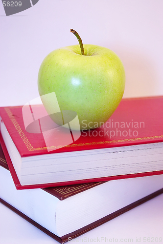 Image of green apple on books