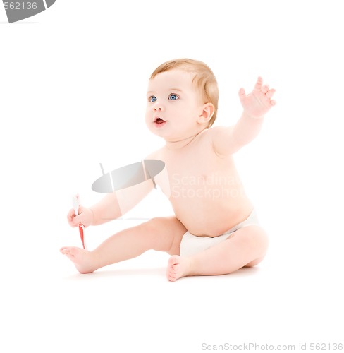 Image of baby boy in diaper with toothbrush